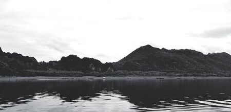 Art landscape of mountain view with river or lake, white sky and Reflection on water at Srinakarin...