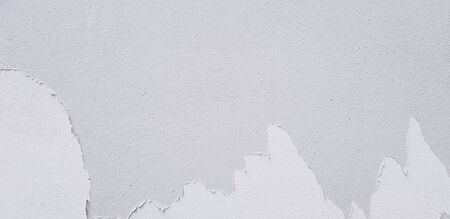 White painted cracked on cement wall for background with copy space - Bad painting, Damaged and Old grunge wallpaperの写真素材