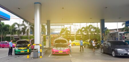 Bangkok, Thailand - August 17, 2019: Taxi and car parking and opening front hood for filling NGV...