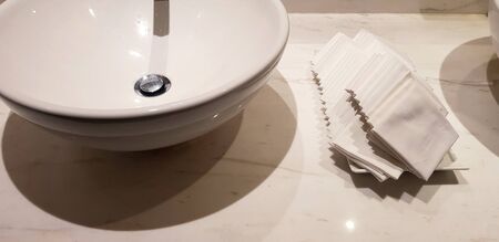 Close up white basin wash with hand towel on white marble in rest room or toilet. Hygiene and cleaning hand or face.の写真素材