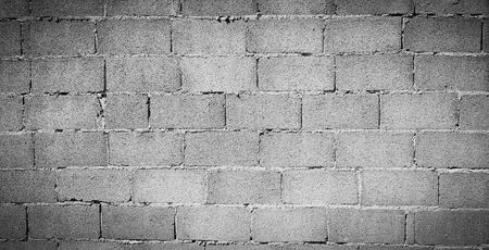 Gray or grey concrete block wall for background at construction site. Rough cement wallpaper make by...