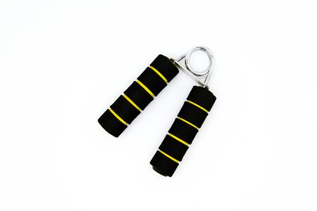 Black and yellow line spring grip or hand trainer tool isolated on white background. The object for...