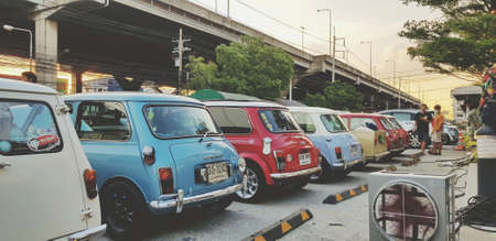 Bangkok, Thailand - June 20, 2020: Many colorful mini Austin classic or cooper parked on street for group meeting with highway background. Vintage car or Retro style and Old vehicle conceptのeditorial素材