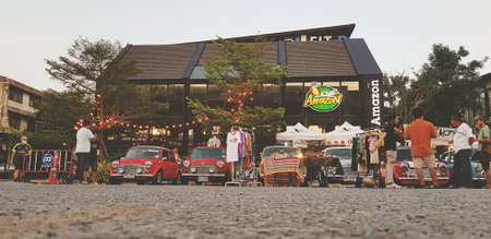 Bangkok, Thailand- June 20, 2020: Low perspective view of Classic mini cooper parked with people...