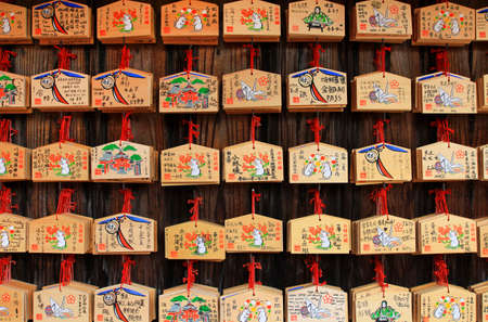 Japan- February 22, 2019: Many wooden fortune amulets
hanging on wall in Japanese temple or shrine at Tokyo, Japan. Pattern of object, Wood material , Faith or belief of people in Asian and Religion.のeditorial素材