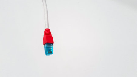 Local area network or LAN cable with red boot cover modular isolated on white background with copy space. RJ45 connector, communication wire and Technology of communication or Information technologyの写真素材
