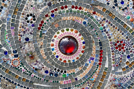 Many jewel or gem, colorful gravel and red diamond in middle or center decorated on wall for background. Pattern of stone or mosaic wallpaper at Thai temple. Art designの写真素材