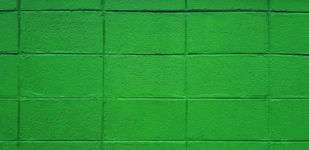 Green brick or block wall for background in vintage tone. Pastel and colorful painted of brickwork wallpaper.の写真素材