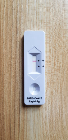 Covid antigen test kit on wooden table  for people testing infected with corona virus by by self before go to see doctor at hospital. Healthcare Tool for checking health on wood background.の写真素材