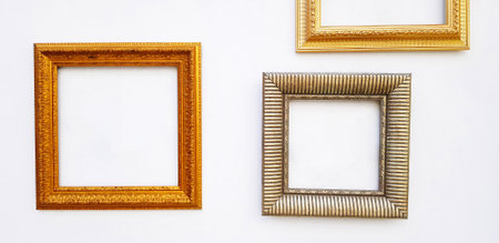 Many empty colorful picture frame mock up on white concrete wall with copy space for add or fill...