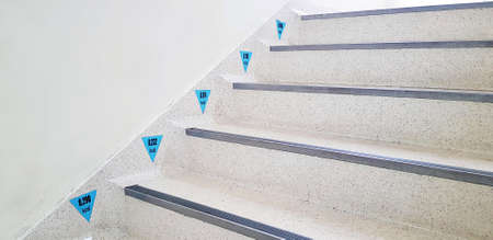 Black number and blue sign of waste calories when people going up and going down staircase or...