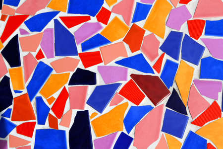 Colorful of Abstract tile background on white wall. Art of broken or crack red, orange, blue, black, pink brown and vioet or purple tile wallpaper.の写真素材