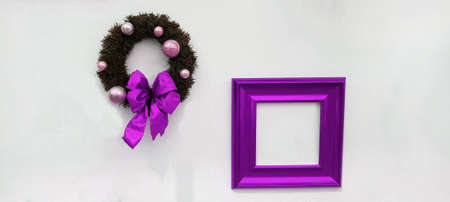 Christmas, happy new year wreath decoration with purple ribbon, white ball and violet picture frame for add wording isolated on white wall background. Object for party, festival wiの写真素材