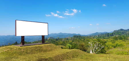 Empty or mockup sign for add or fill wording or text with forest or jungle, mountain, clear blue sky and cloud background at national park. Beautiful natural and Advertisementの写真素材