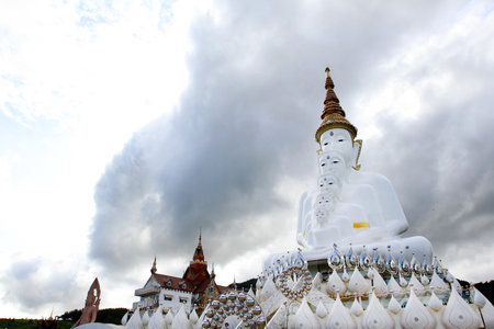 Big white monk statue with sky and white cloud background with copy space at Thai temple Phetchabun, Thailand. Landmarks and famous place for travel. Religion and Art of sculptureの写真素材