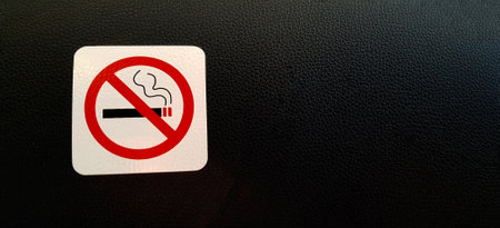 Do not smoke sign or symbol on black leather background or wallpaper with copy space. Strict place or area not allow smoking. Rule conceptの写真素材