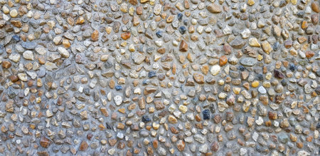 Gravel stone or hard rock pattern wall for background. Exterior structure design in loft style and Natural art of wallpaper conceptの写真素材