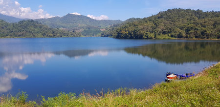 Landscape view of lake or river with boat, green mountain hill and blue sky background at Huai Bon reservoir Chiang Mai, Thailand. Park, Beauty of nature and Natural wallpaper. Lanの写真素材