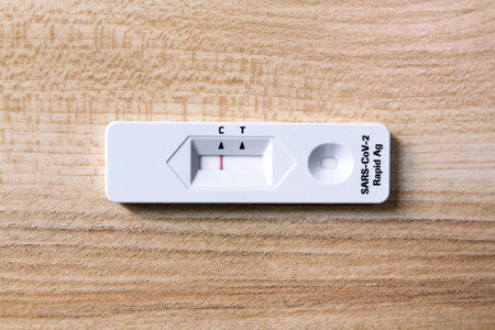 Negative test result by use antigen rapid test for COVID-19 on wooden background with copy space. Healthy check, Corona virus infection, Pandemic infectious and Medical. Initial syの写真素材