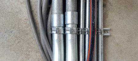 Stainless steel, gray or grey rubber pipeline installed on wall or floor background with copy space...