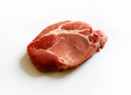 Close up fresh sliced pork, meat or beef isolated on white background. Uncooked food. Freshness piece of steak prepare for grill or fried.の写真素材