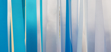 Blue and white ribbon background or wall. Pastel and colorful paper or fabric decoration in party, festival, wedding, new year and celebration concept.の写真素材
