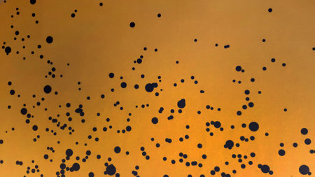 Abstract yellow with pattern black dot painted wall background or art wallpaper.の写真素材