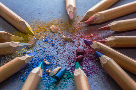 Multicoloured pencils, shavings and fragments of broken cores on grey backgroundの写真素材