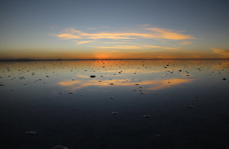 Sunset over Uyuni salt lake in Boliviaの写真素材