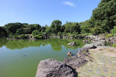 Iso-watari (step stones) and Dai-Sensui Pond in Kiyosumi Garden, Tokyo, Japanの写真素材