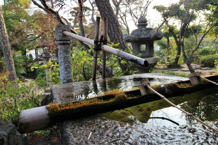 Chozubachi (water bowl) at Shinkei-en (Japanese garden) in Kurashiki Bikan Historical Quarter, Japan