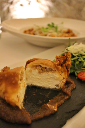 Maltese cuisine: Maltese goat cheese parcel (cut) with fig jam and petit salad in Valletta, Malta