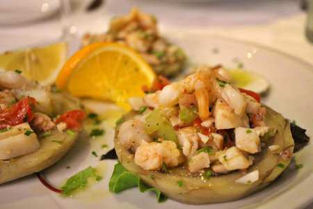 Italian cuisine: seafood salad with artichokes in Venice, Italyの写真素材