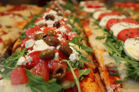Varieties of Italian pizzas displayed in a vitrine in Venice, Italy