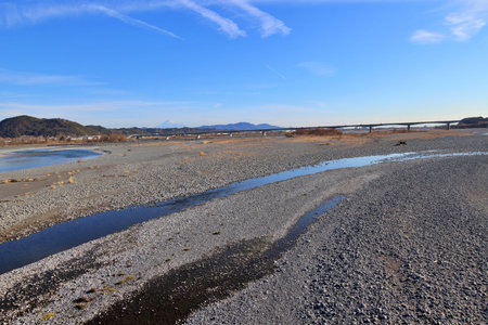 Mount Fuji viewed over the Oi River from Horai Bridge, the longest wooden pedestrian bridge in the...