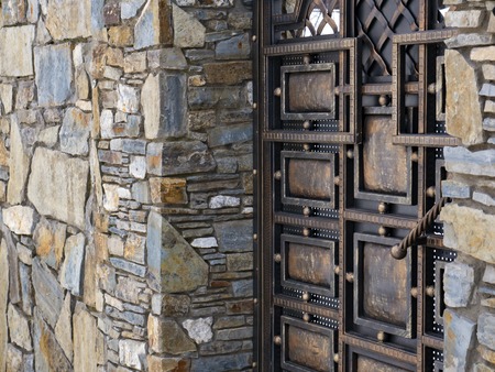 The texture of the wall paved with stone and metalの写真素材
