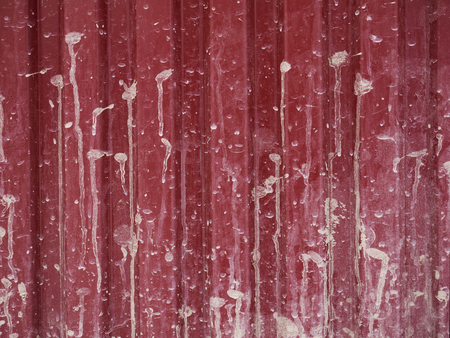 Red texture of the fence with gray dirtyの写真素材