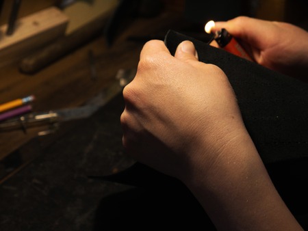 Leather handbag craftsman at work in a workshop