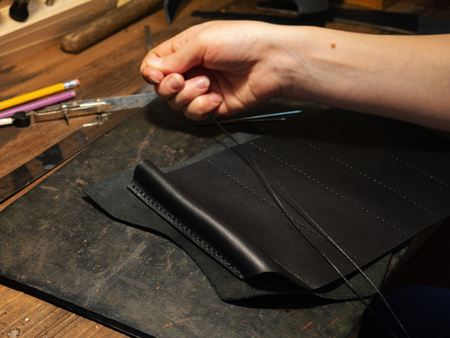 Leather handbag craftsman at work in a workshop
