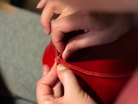 Leather workshop Hands of the girl Red leather Handmade