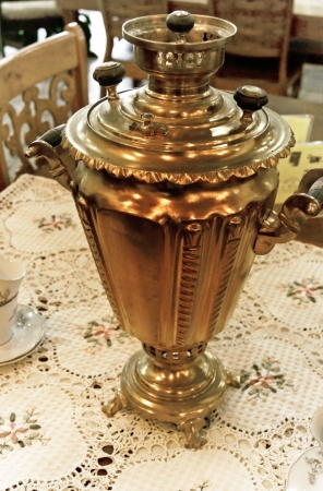 An old teapot from copper in Russian style on the table の写真素材
