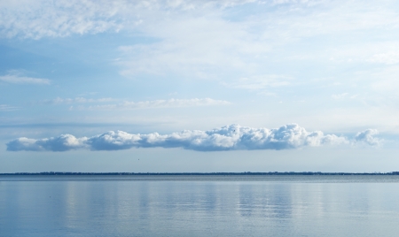 Long cloud over the sea at sunrise, monochrome viewの写真素材