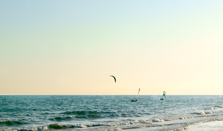 Various water sport activities on the sea at sunsetの写真素材