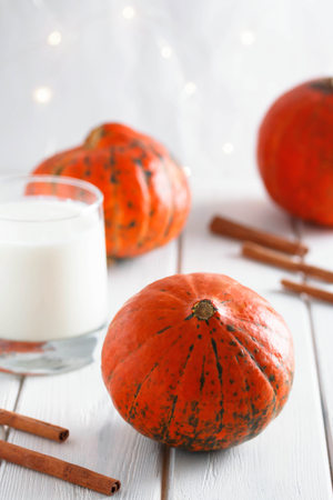 Pumpkin on cinnamon yogurt background. Pumpkin on old wood background. Halloween background.の写真素材