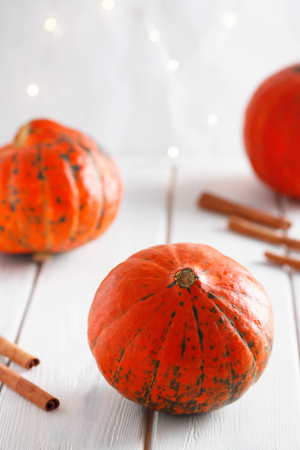 Pumpkin and cinnamon background. Pumpkin on old wood background. Halloween background.の写真素材
