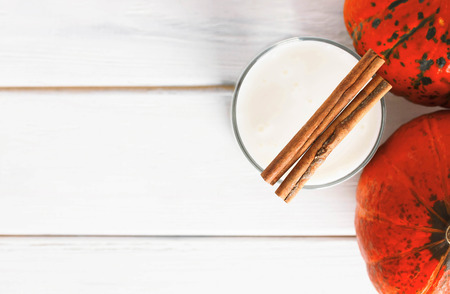 Pumpkin yogurt and cinnamon on a white background old wood.の写真素材