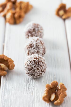 Homemade natural candy made from nuts, fruit dates and coconut. Healthy vegan food.の写真素材