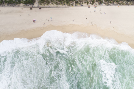 Aerial view of sandy beach with tourists