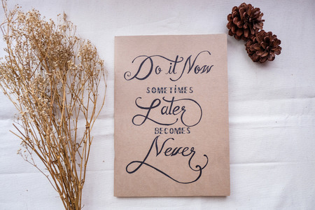 Inspirational motivating quote on notebook with  handwritten typography