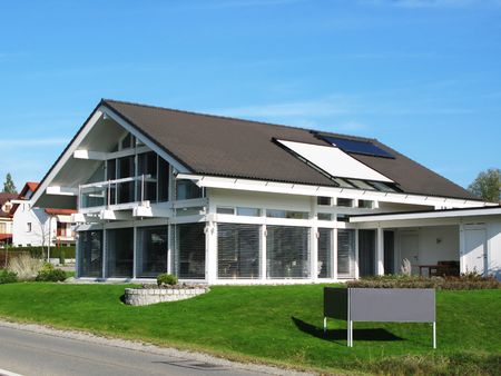 Modern house. Empty signboard in frontの写真素材